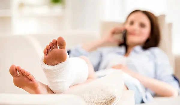 Woman with broken leg on couch